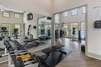 View of the fitness room with cardio equipment and mirrors